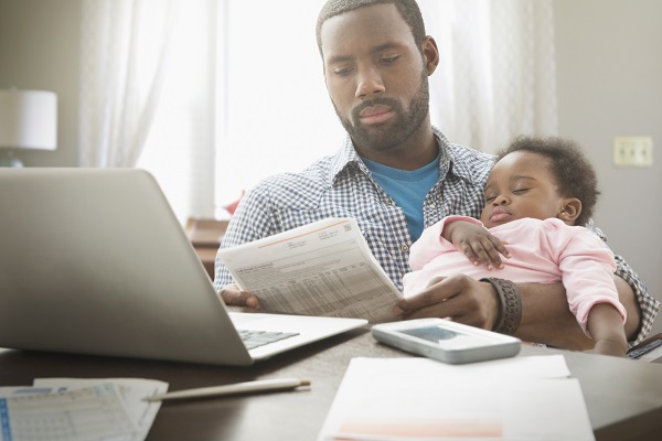 man with baby at computer
